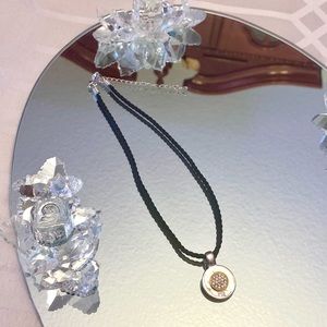 black necklace w/ silver & gold pendant